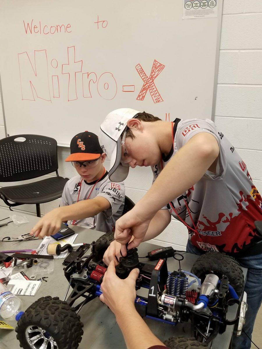 Campers working on a car