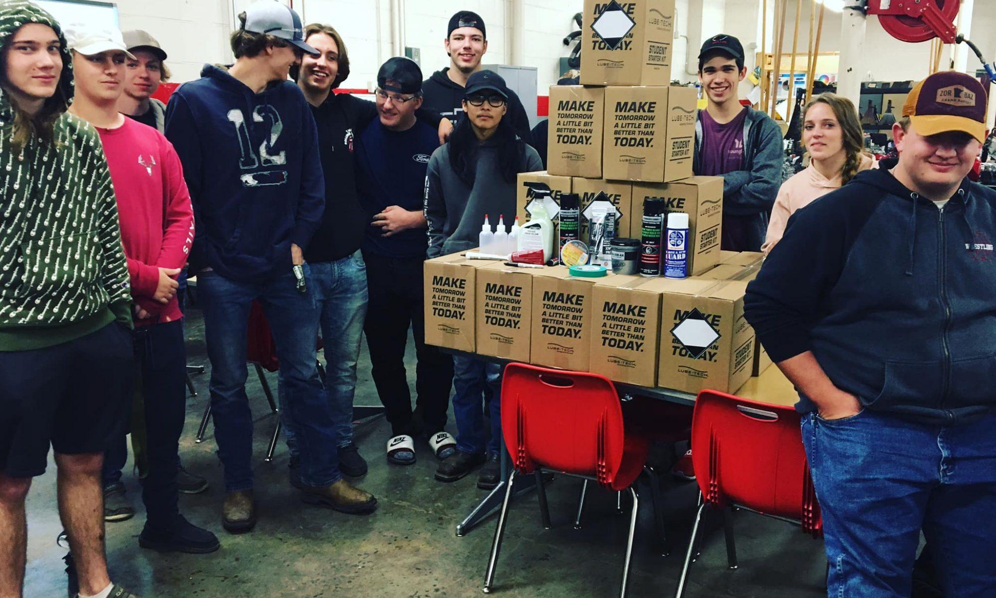 Students standing around a lube-tech donation