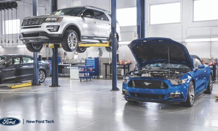 Inside of an auto shop with 2 cars