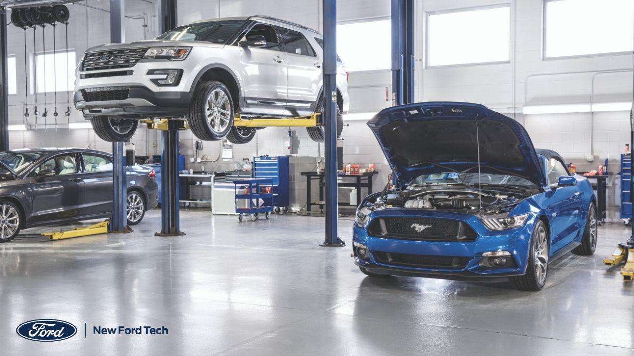 Inside of an auto shop with 2 cars