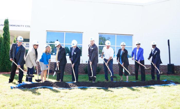 group of people holding shovels