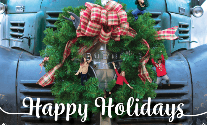 Holiday card with a wreath on the front of a truck