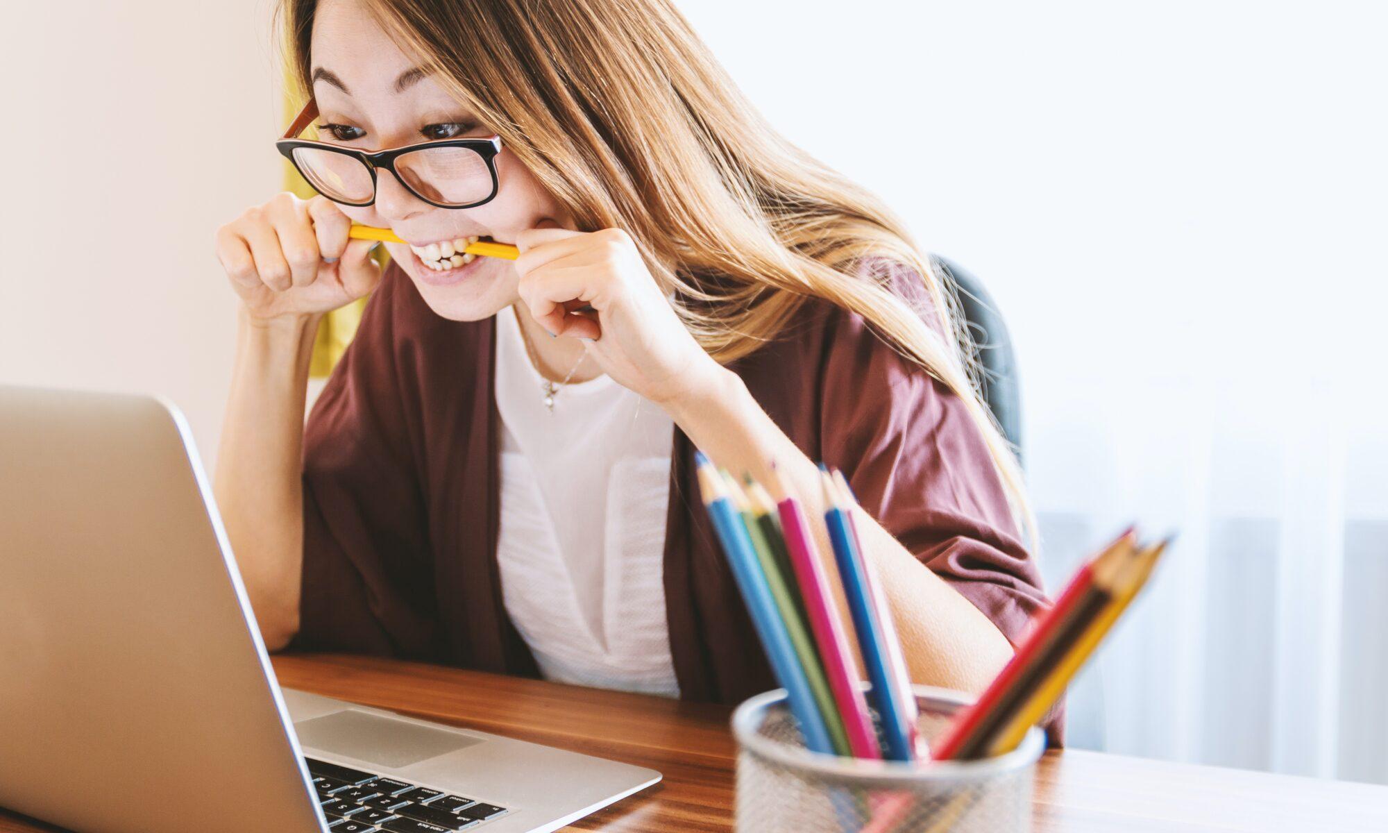 student biting a pencil out of stress