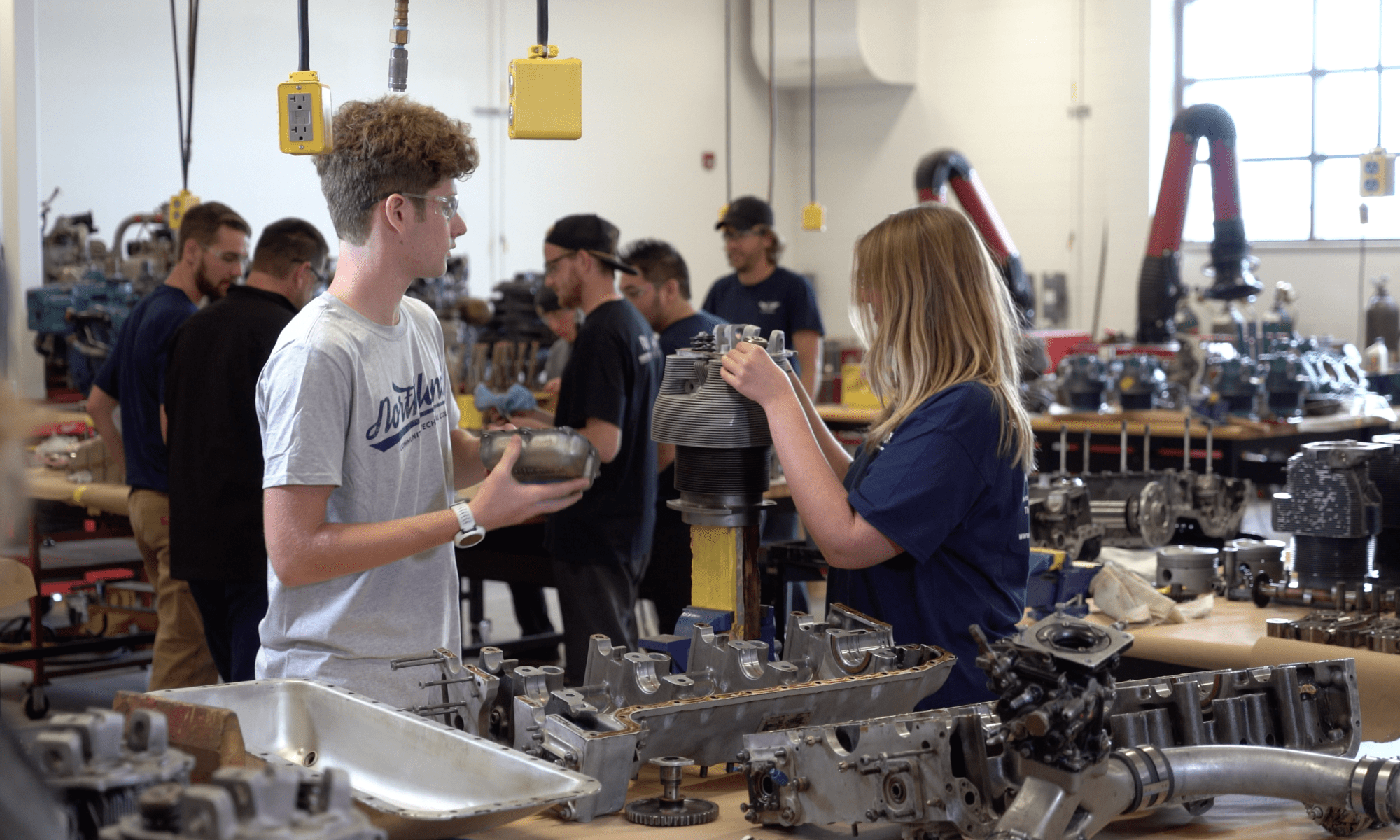 Students working on an airplane part