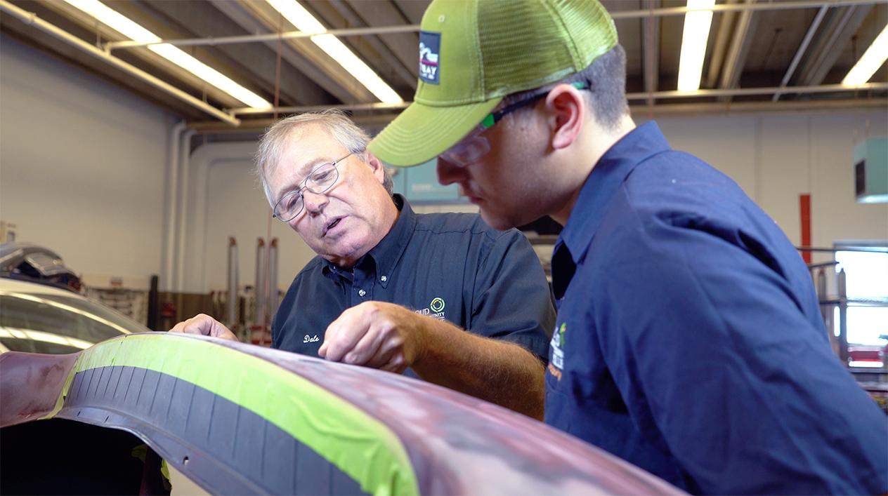 auto body teacher instructing a student