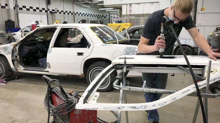 auto body student working on a door