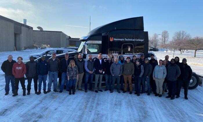 Industry partners and teachers standing in front of the donated semi truck