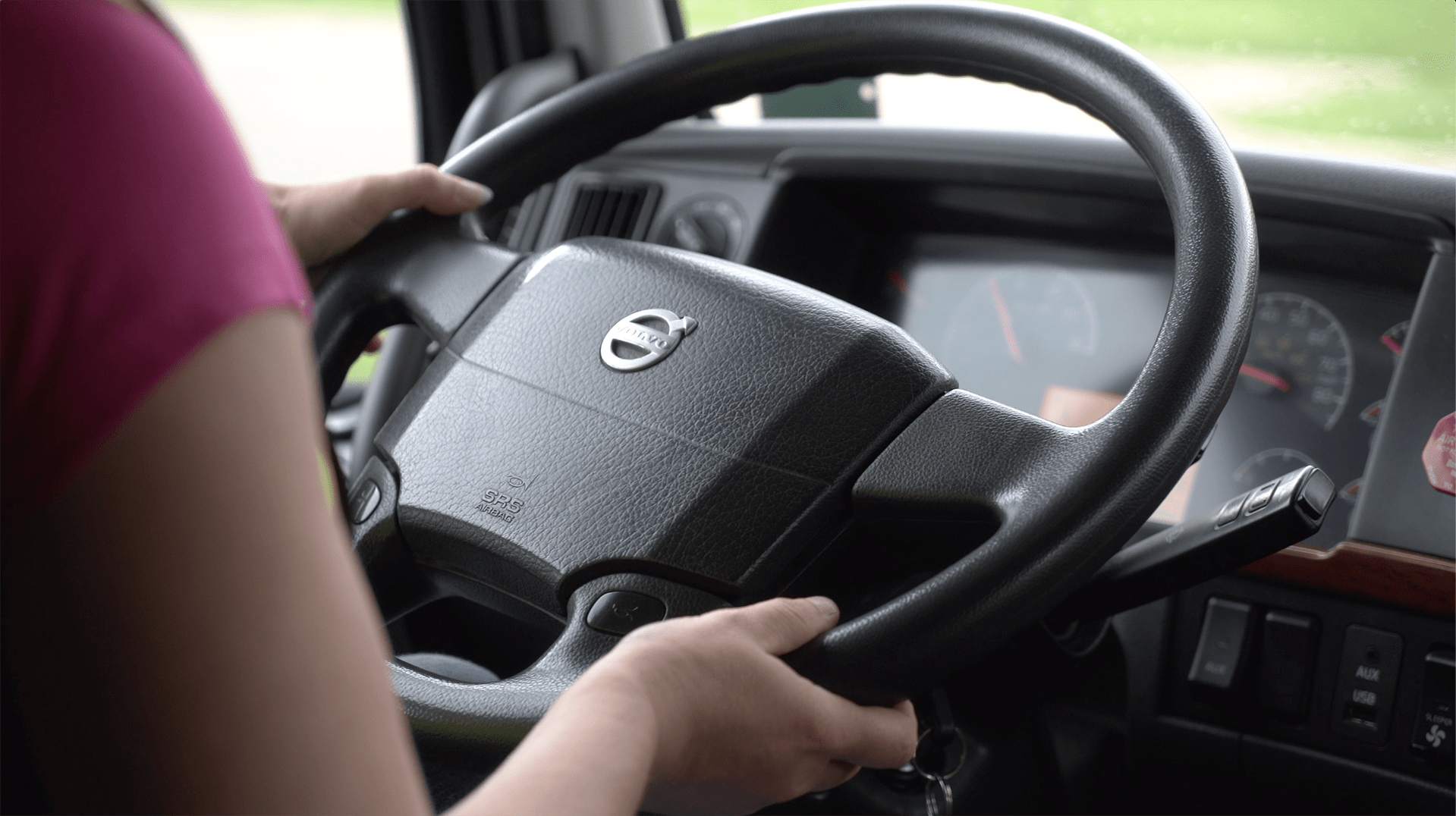 hands on the steering wheel of a semi