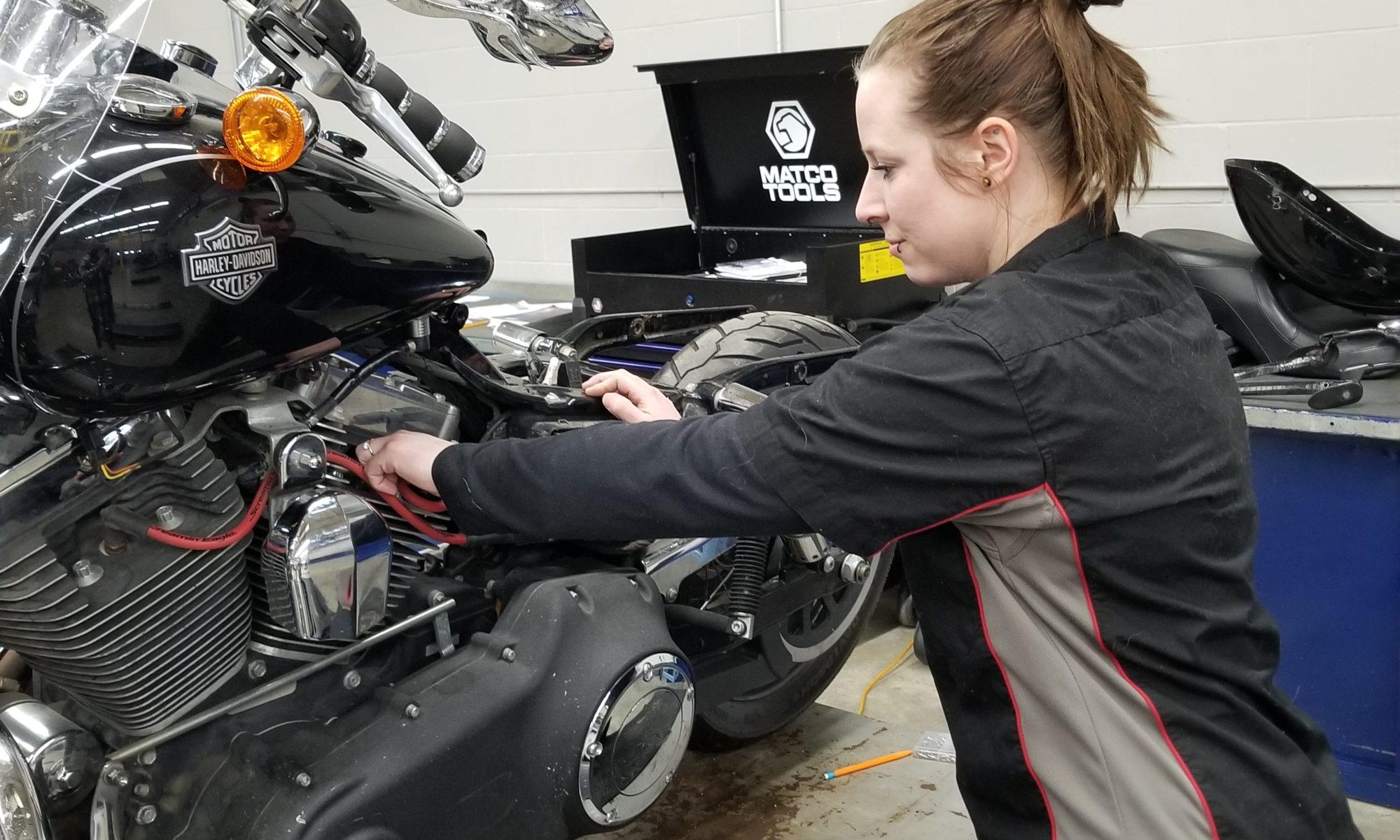 student working on a motorcycle