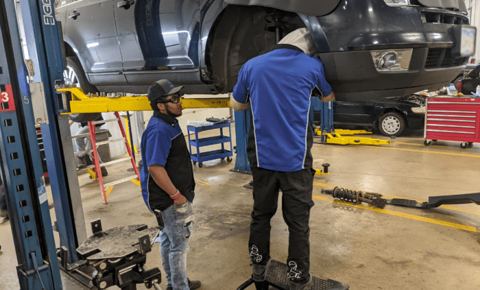 student working on car